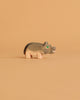 The Ostheimer Hippopotamus - Small is a handcrafted wooden figurine with painted details, shown on a light brown background—ideal for imaginative play.