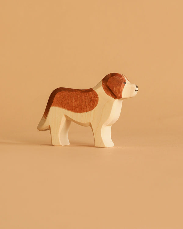 The Ostheimer Saint Bernhard Dog is a handcrafted wooden toy, painted with brown and white patches, set on a light beige surface against a matching background—ideal for imaginative play and echoing classic Ostheimer design.