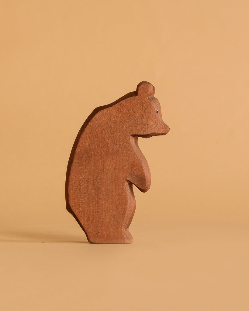 The Ostheimer Handmade Wooden Bear Set features upright, minimally detailed wooden bear figures with simple, abstract designs, inspired by classic Ostheimer toys and perfect for display on any flat surface.