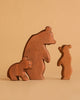 The Ostheimer Handmade Wooden Bear Set features one large and two small handcrafted bears, arranged on a beige background to resemble a bear family. Made from sustainably sourced wood, this set celebrates timeless, simple design.