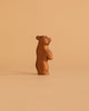 The Ostheimer Handmade Wooden Bear Set features a small, handcrafted wooden bear figurine standing upright on a plain beige background. The simple, stylized design is reminiscent of classic Ostheimer toys with minimal details and timeless charm.