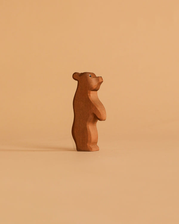 The Ostheimer Small Bear - Standing is a handcrafted wooden figurine that stands upright, showcasing sustainable toy craftsmanship and care.