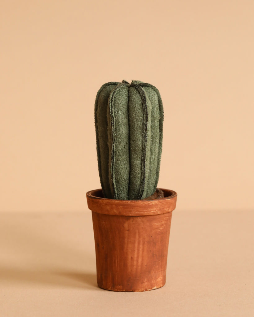 A green fabric cactus in a brown terracotta pot sits on a beige background—an ideal accent for the Maileg Little Sister Bedroom Set.