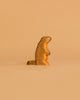 The Handmade Holzwald Marmot, a small wooden figurine, stands upright against a plain light brown background—an adorable and eco-friendly addition to any sustainable toy collection.