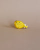 A high-quality Handmade Holzwald Pufferfish toy painted yellow with black spots, positioned against a plain beige background.