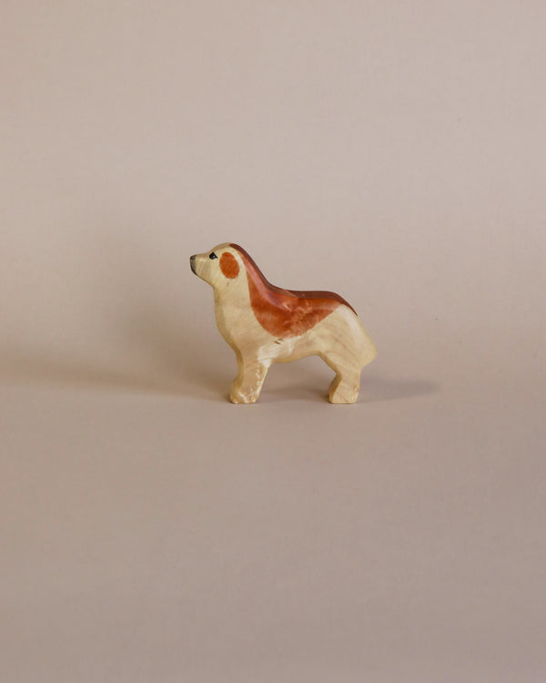 Sentence with product name: A small ceramic figurine of a Handmade Holzwald Golden Retriever with a high-quality glossy finish, standing against a plain light beige background. The dog is painted in shades of white, tan, and brown.