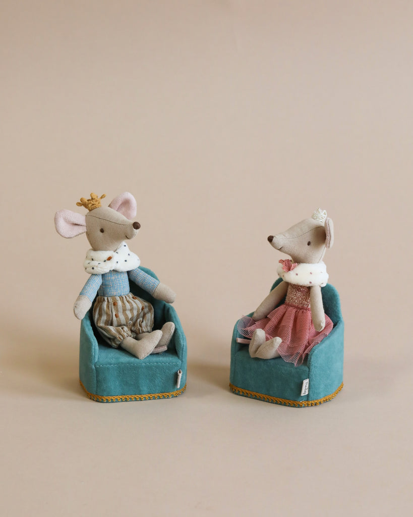 Two Maileg Royal Mice, King Mouse and a fox, dressed in royal outfits and sitting in turquoise chairs against a beige background. King Mouse wears a crown and the fox wears