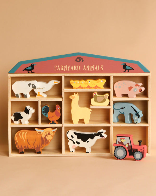 A sustainably sourced rubberwood toy shelf labeled "Farmyard Animals Set" displaying various animal figurines, including a pig, sheep, horse, duck, cow, chicken, goat, and a tractor.