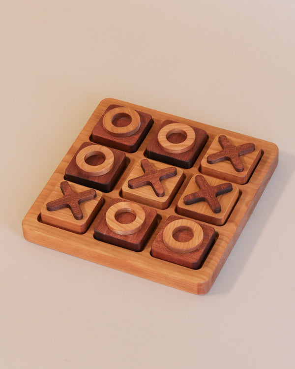 Wooden Tic-Tac-Toe Game - Made in USA with x and o pieces in a game in progress, set against a neutral background.