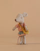 The Maileg Little Brother and Sister Bedroom Set features a small gray mouse in a pink striped shirt, plaid skirt, and yellow bag standing upright against a plain beige background.