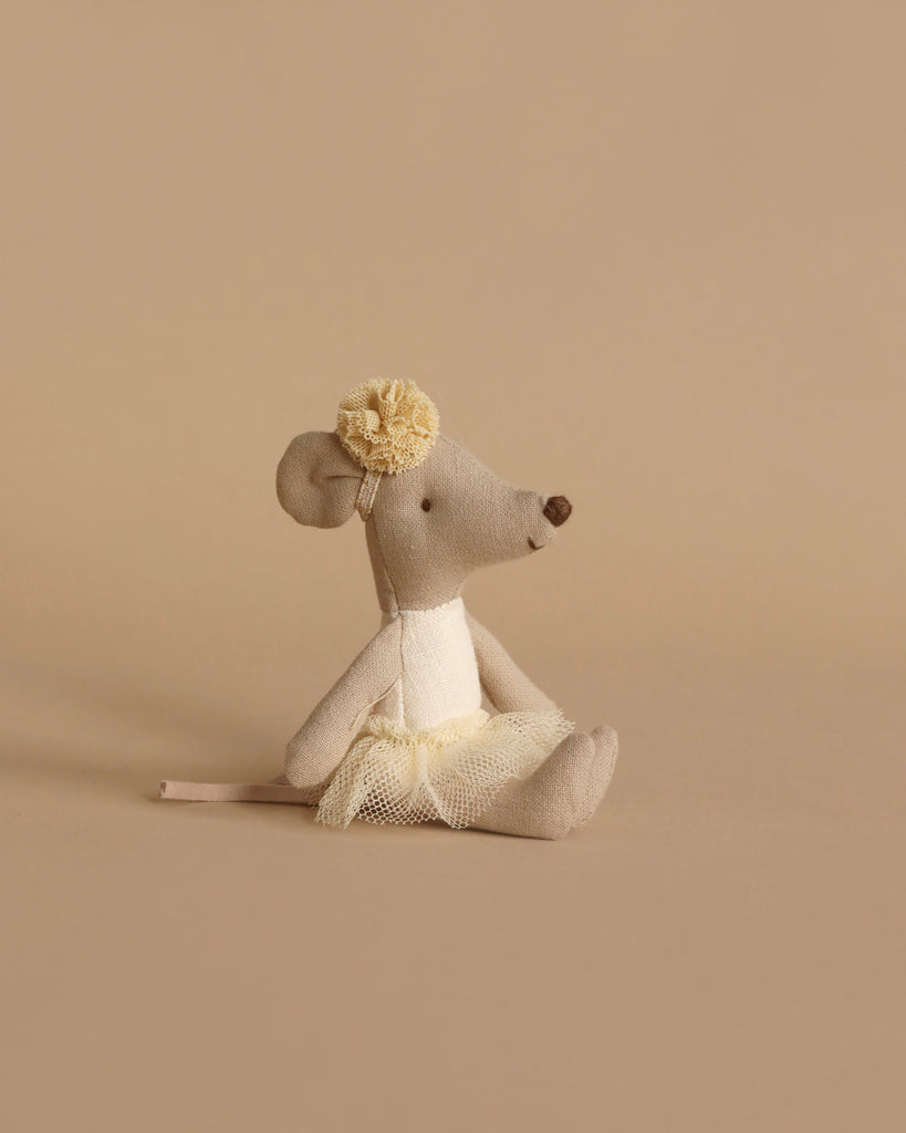 A soft, beige plush mouse doll in a tulle skirt and flower headband sits upright against a beige background, ready for teatime with her Maileg Family Time Living Room Set or to complement any mouse dollhouse furniture.