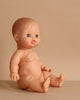 The Minikane Doll with Sleeping Eyes (13") - Lily With Clothing is an anatomically correct doll made in Spain, featuring sleeping eyes and dressed, seated with slightly bent arms and legs against a plain beige background.