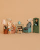 The Maileg Grandparents Set features three mice seated around a small table with a teapot and snacks in a cozy, dollhouse-style room, surrounded by Maileg accessories like a lamp, green cabinet, and soft neutral décor.