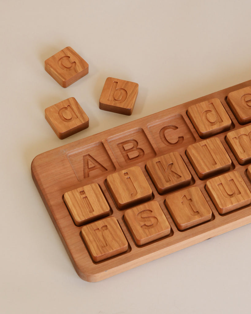 Extra Large Uppercase & Lowercase Alphabet Puzzle with lower case letters a to z in individual slots and a few detached blocks, on a light beige background.