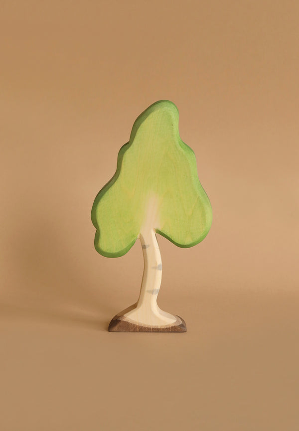 This whimsical and rounded Ostheimer Birch Tree, Small features light green foliage and a pale brown trunk. The base of the tree is slightly darker brown. Handcrafted using sustainably sourced materials, it showcases a simple, hand-painted style typical of Ostheimer toys, all set against a white background.