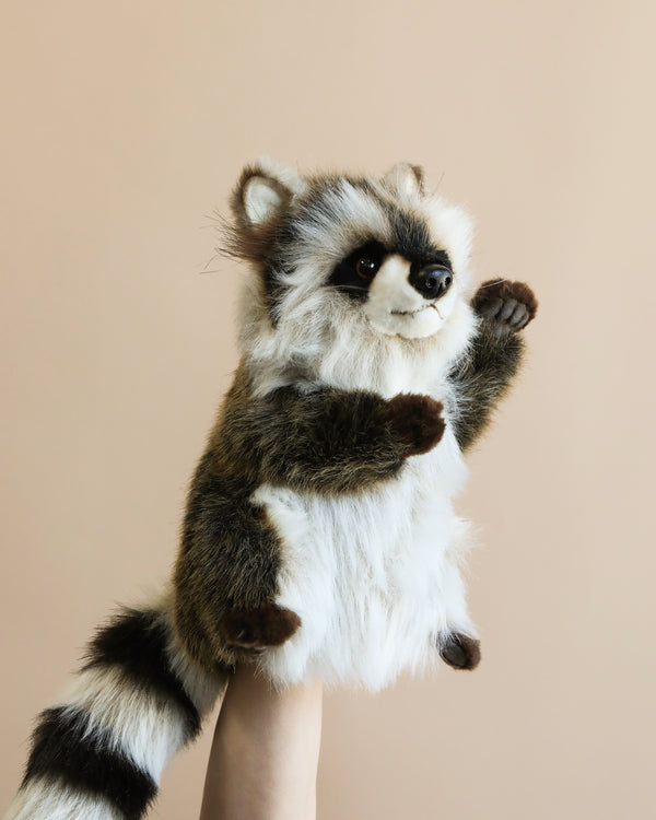 A plush Raccoon Puppet, hand sewn against a beige background, showcasing detailed fur patterns and a playful stance.
