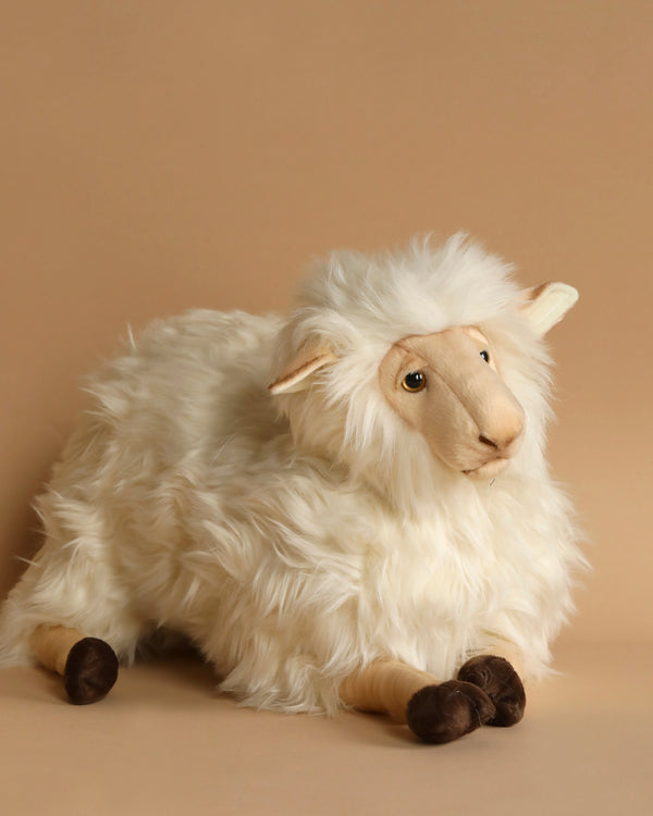 The Mama Sheep Stuffed Animal, with its white fluffy fur, black feet, and calm expression, showcases hand-sewn craftsmanship against a white background.