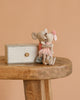 The Maileg Big Sister and Me Set features two charmingly dressed mice hugging on a wooden stool beside a small decorative box, all against a plain beige background.