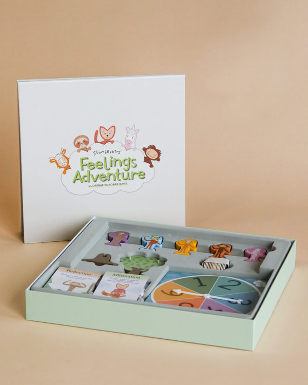 A box of children's puzzles titled "Slumberkins Feelings Adventure Board Game" featuring colorful animal figures, displayed next to its packaging on a beige background.