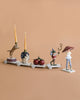 The Magical Forest Birthday Train With Beeswax Candles features four whimsical carts: a tiger with candles, a rabbit in a starry hat, two cherries, and a parade leader in a mushroom hat—perfect for birthday celebrations with interchangeable numbers.