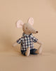 A Maileg Dad Mouse dressed in a checkered shirt and denim pants, sitting upright against a plain beige background.