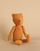 The Maileg Gift Box: Little One’s First Friends features a simple brown fabric teddy bear with stitched facial features, sitting upright against a plain beige background.