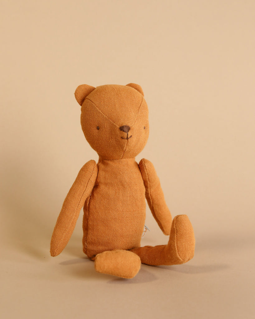 The Maileg Gift Box: Little One’s First Friends features a simple brown fabric teddy bear with stitched facial features, sitting upright against a plain beige background.