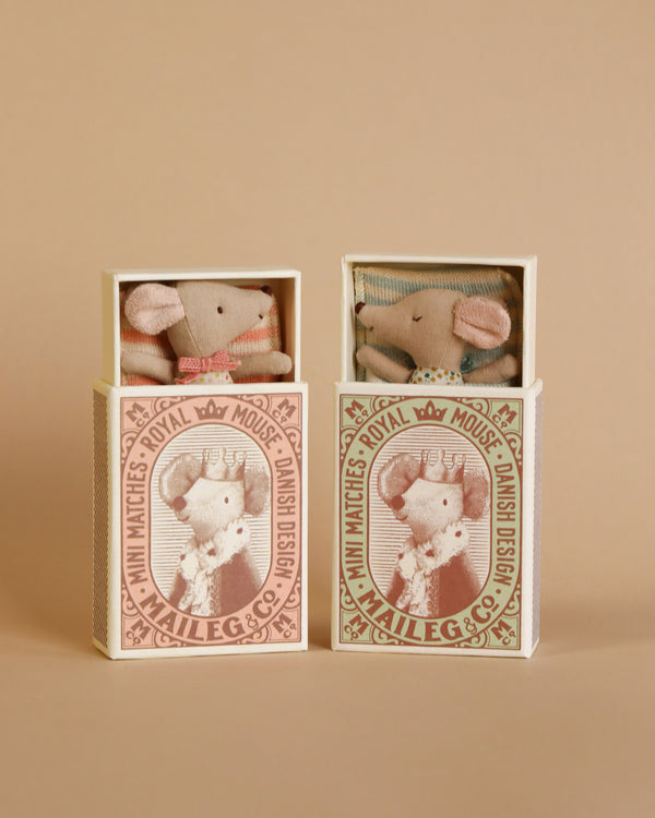 two small boxes each with a mouse doll inside. 