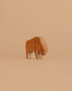 The Ostheimer Bison, Small is a handcrafted, minimalist wooden animal figure in light brown, inspired by traditional German Ostheimer toys. It stands on a plain beige background and features simple artisanal details.