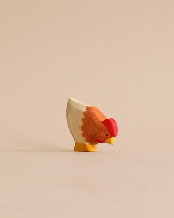 A high-quality Handmade Holzwald Hen painted in white and shades of orange, facing left on a light beige background.