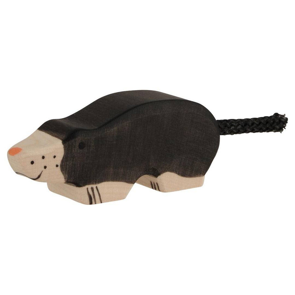 The Holztiger Mole is a small, handcrafted wooden toy painted black with a beige face, orange nose, dot eyes, and braided tail—a charming European-made figure.