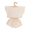 Introducing the Mrs. Ertha Doll Clothes - 13″-14″ - Ivory Comfy Set: a cream-colored, handmade outfit for Minikane doll clothes collections featuring a short-sleeve top and drawstring shorts, beautifully presented on a hook-shaped cardboard hanger.