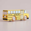 A yellow retro wooden school bus, labeled “No. 47 GT285 Rufus | Made in England,” features classic black stripes, detailed windows and doors, and rolling wooden wheels—capturing timeless American charm and sparking imaginative adventures.