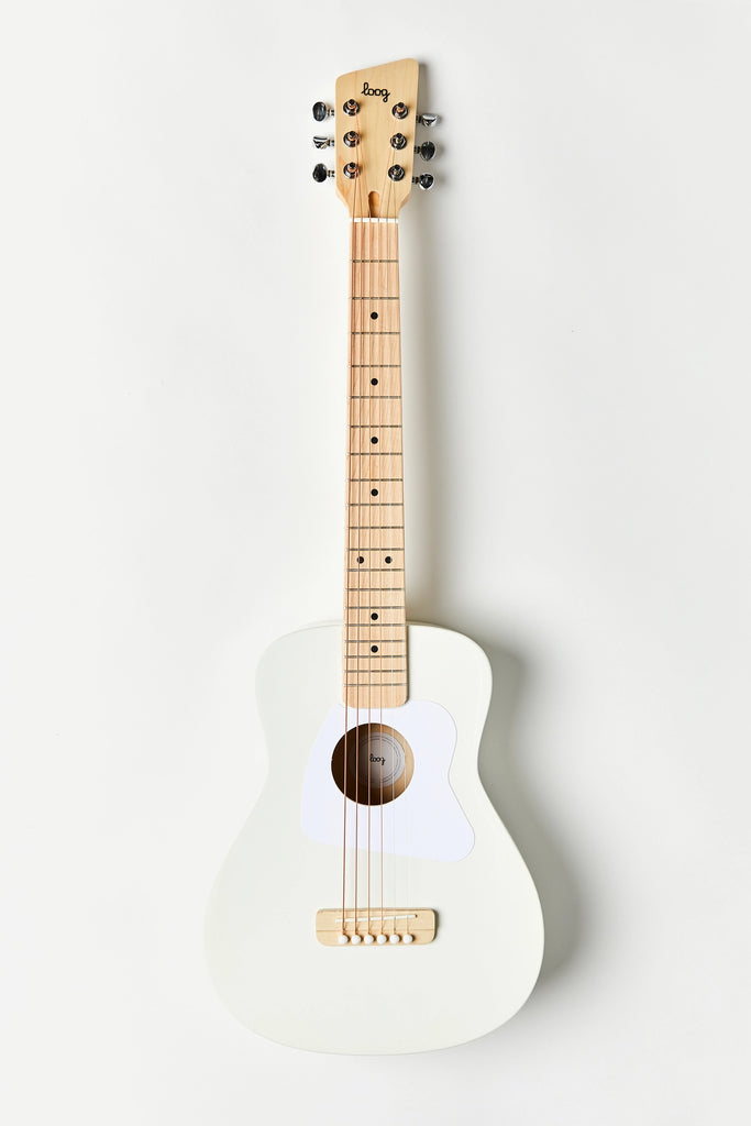 A white acoustic guitar with a natural wood neck and fretboard, featuring six tuning pegs and a white pickguard. Crafted from real wood, this Loog Pro Vi Acoustic Guitar Ages 9+ (ships in approximately one week) boasts a clean and minimalist design, set against a plain white background. Perfectly paired with the intuitive Loog Guitar app for learning.