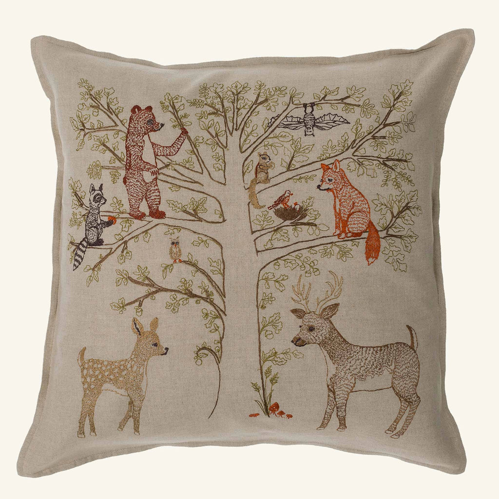 The Coral & Tusk Woodland Living Tree Pillow (ships in one week) features embroidered forest animals—bear, raccoon, owl, rabbit, fox, squirrel, and deer—gathered in a leafy tree to celebrate your woodland family.