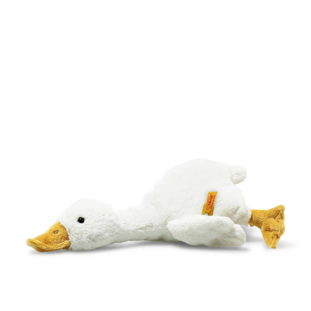 A Steiff Goose Stuffed Plush Animal lying on its side, with a visible yellow bill and feet, against a white background.