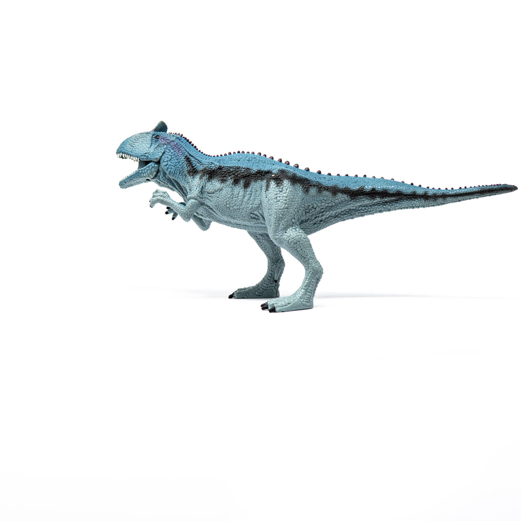 A Schleich Cryolophosaurus Dinosaur Toy with Movable Jaw, featuring a blue and gray theropod design, stands on a white background with its mouth open and small arms raised.