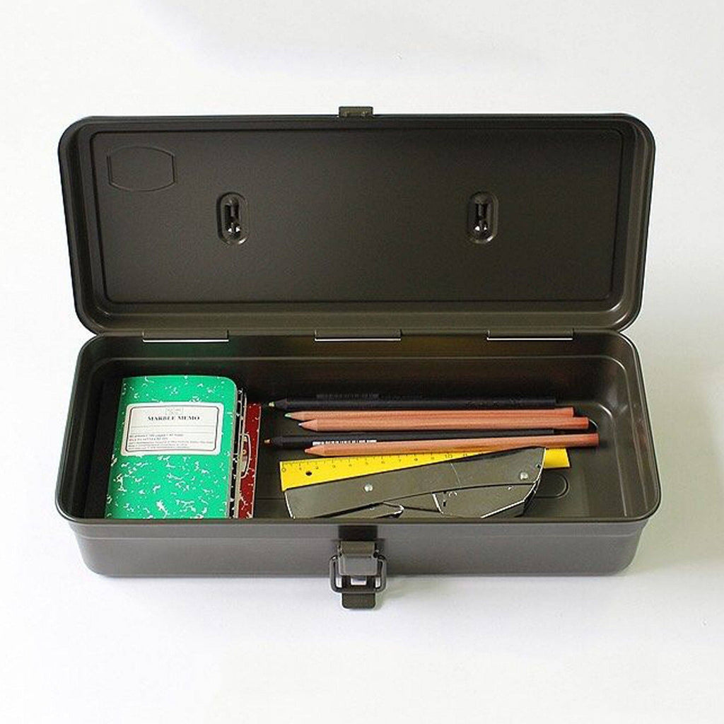 Open black Multi Purpose Steel Storage Box T-320 containing a notebook, several pencils, a yellow ruler, and a metal utility knife.