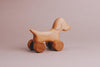 Handmade Wooden Mini Dog Push Toy on wheels set against a plain background, evoking the charm of a classic giraffe push toy.