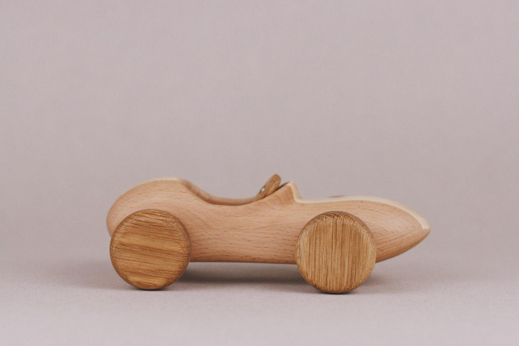 Introducing the Handmade Wooden Race Car, crafted from beech wood with intricately designed wheels. This toy car boasts an ultra-smooth finish and is elegantly treated with natural linseed oil for a sleek touch.