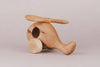 The Handmade Wooden Helicopter is a charming toy featuring two wheels and a clean, simple design. It is crafted from light-colored wood and finished with natural linseed oil, enhancing its graceful appearance.