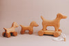 A delightful handmade push toy featuring a mini dog design, crafted from maple and beech wood, elegantly created for endless playtime adventures.