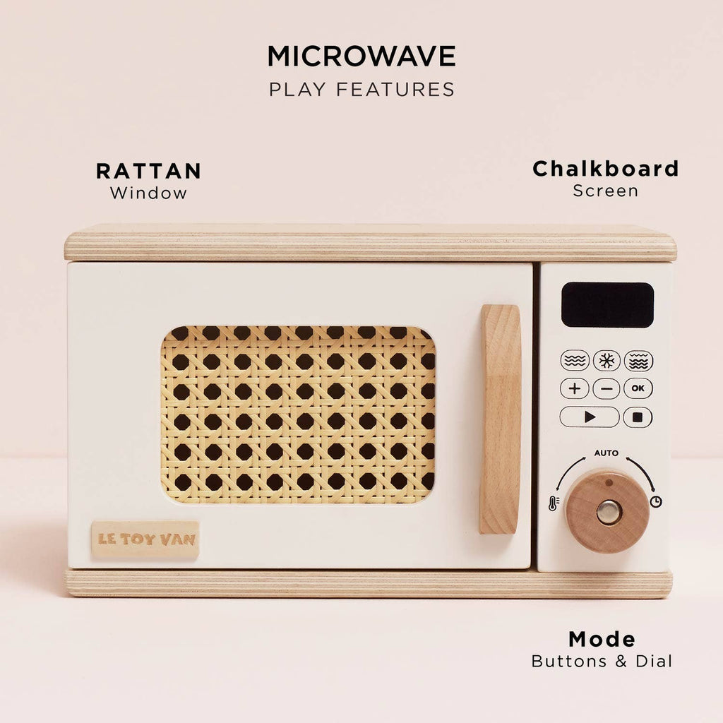 The Wooden Microwave (ships in one week) is made from sustainable wood, featuring a rattan window, labeled buttons and dial, chalkboard screen, and "Le Toy Van" branding—ideal for any play kitchen.