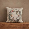 The Coral & Tusk Tree Trimmers Wreath Pillow, in beige with embroidered woodland animals like a fox, bear, owl, rabbit, squirrel, and goat among pine branches and cones, adds festive charm to your seasonal decor.
