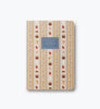 Introducing the Assorted Set of 3 Schoolhouse Notebooks—each with a patterned cover featuring apples, books, pencils, and paint tubes. A central label on a blue background reads “Ruled Paper 50s Notebook Ruled Paper.” These stitched notebooks offer convenient lay-flat binding for comfortable writing, making them ideal for all your classroom or creative needs.