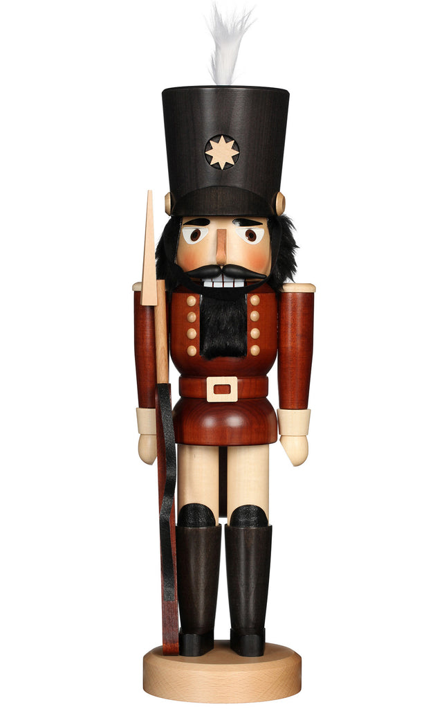 The Christian Ulbricht Collectible Wooden Nutcracker - Soldier features a traditional German soldier with a tall black hat, brown uniform, black boots, and white feather, holding a spear. This classic piece is a charming addition to any collection.