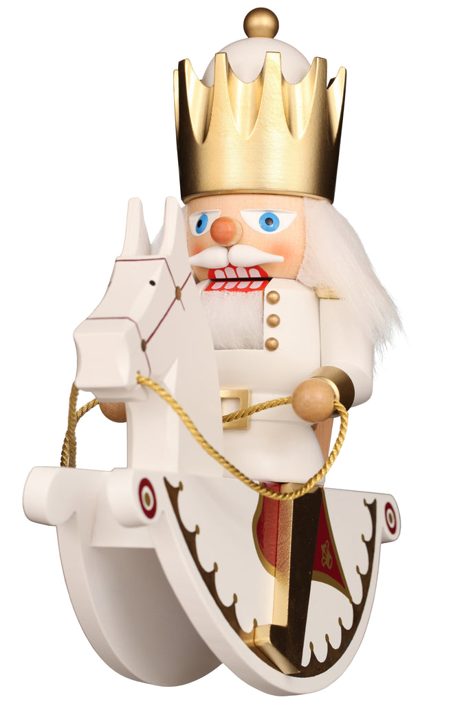 The Christian Ulbricht Collectible Wooden Nutcracker - Rider King features a king with a golden crown, white hair, and blue eyes riding a white rocking horse in a gold-accented uniform—a charming piece for any collection.
