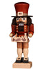 The Christian Ulbricht Collectible Wooden Nutcracker - Toy Trader features a tall red hat, brown beard and mustache, and holds a box adorned with forest and village scenes containing small wooden items.