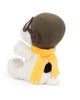 A Plush Peanuts Snoopy Sitting Flying Ace from Bon Ton Toys faces left on a plain white background, wearing a brown aviator hat, goggles, and a yellow bow-shaped scarf—mirroring his iconic look from the classic Peanuts comic strip.