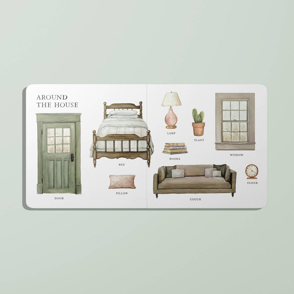 A spread from "Our Big Book of First Words" titled "Around the House" features labeled illustrations of a door, bed, pillow, lamp, plant, books, couch, window, and clock—ideal for any vocabulary board book collection.
